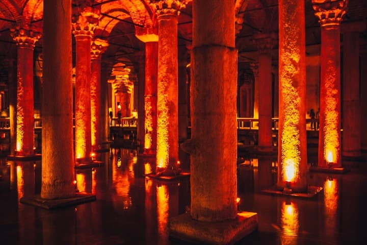 interior de la cisterna basílica iluminado artificialmente, se aprecian las columnas y el agua en la que se refleja la estructura, algo que ver en turquía - weroad