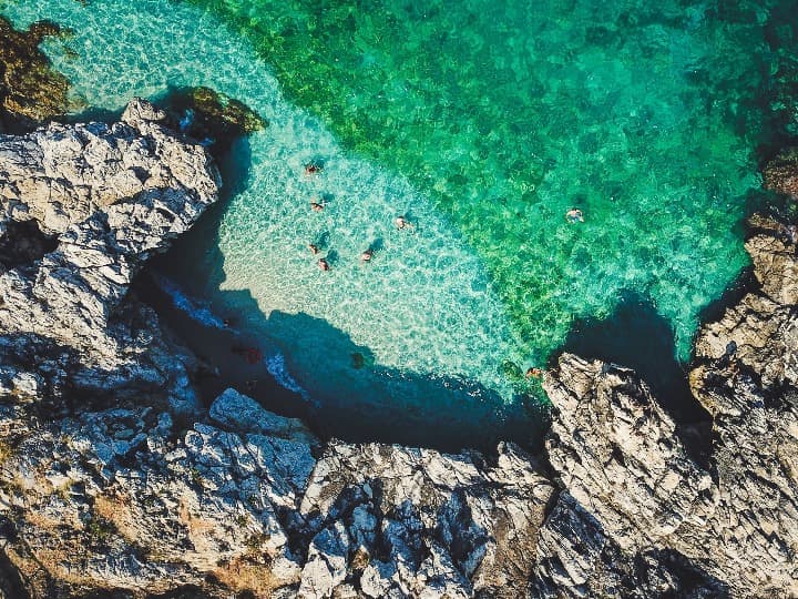vsión aerea de una playa en san vito lo capo, sicilia. agua verde y rocas - weroad