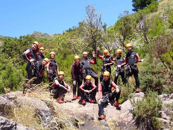 grupo de viajeros weroad vestidos con equipamento para hacer canyoning en madeira