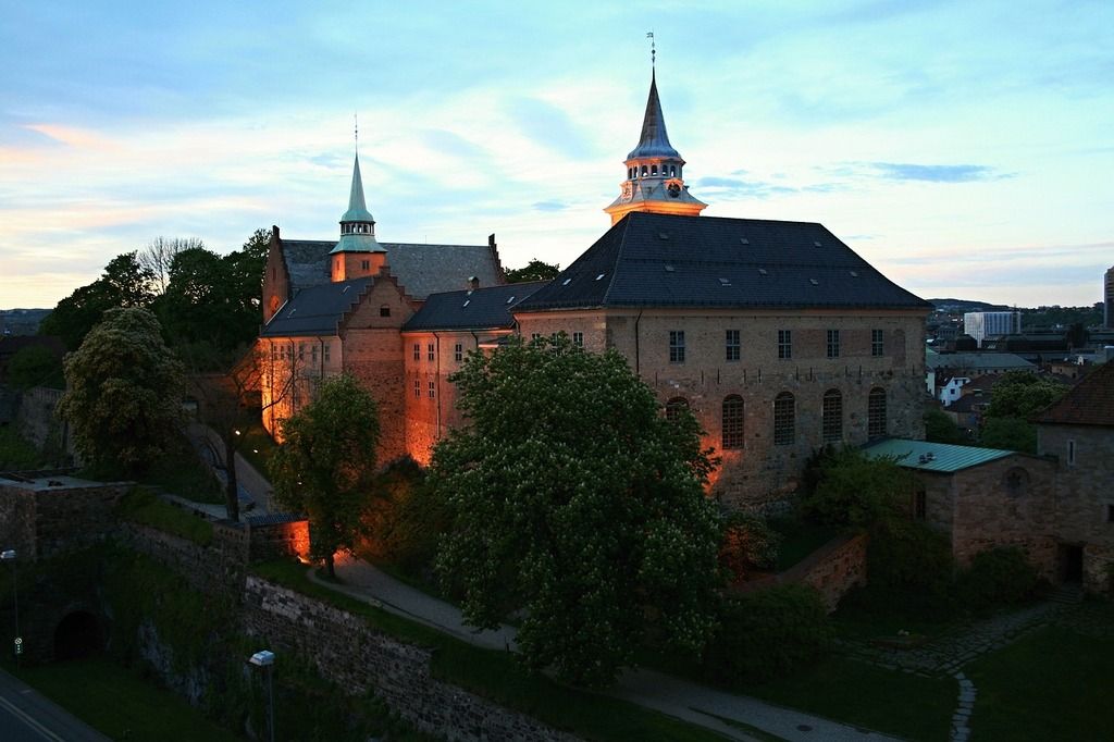 Fortaleza de Akershus iluminada al atardecer en Oslo.